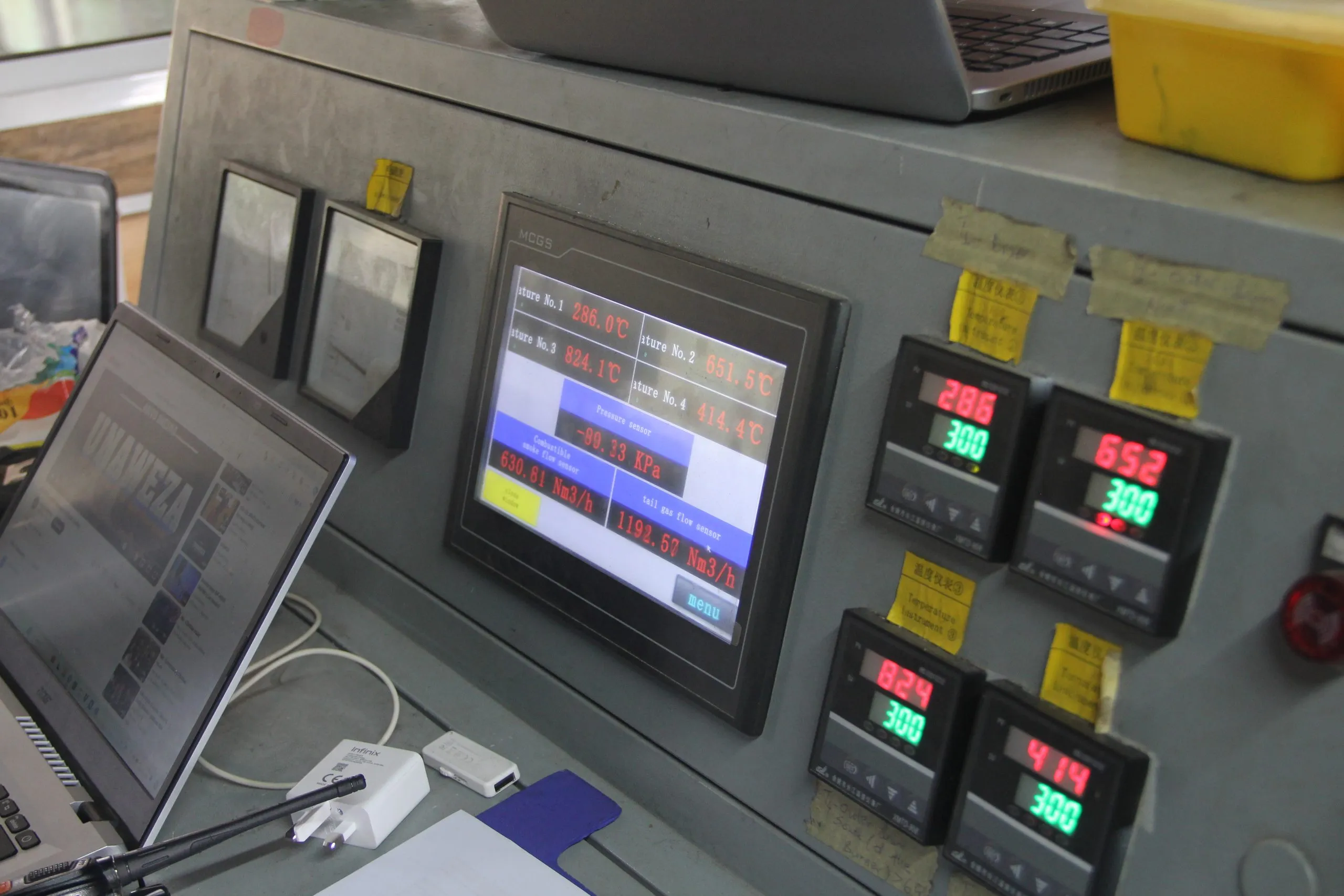 The plant control panel — touchscreen, zone controllers, and the written log kept beside it